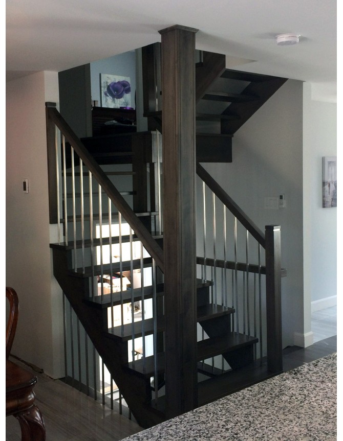Floating staircase with wooden steps and stainless steel balusters
