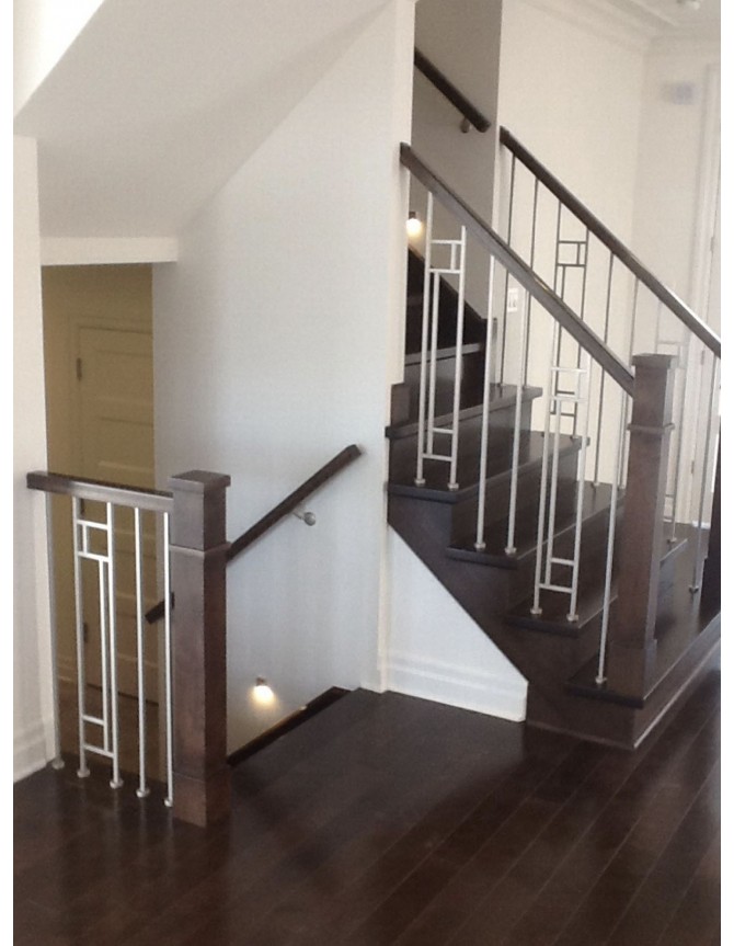 Interior staircase with wooden steps and forged steel balusters