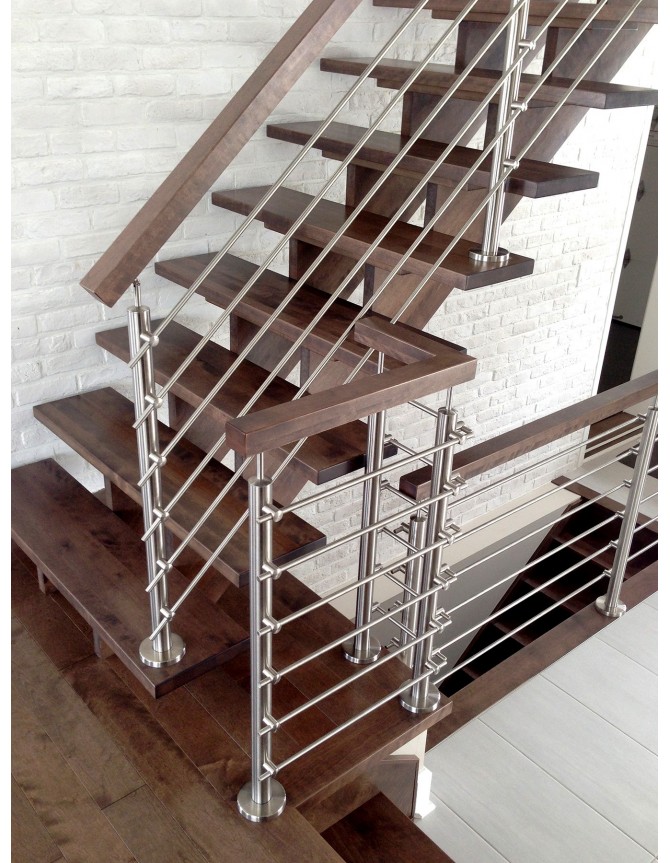 Floating staircase with wood steps and railings and stainless steel rod railings