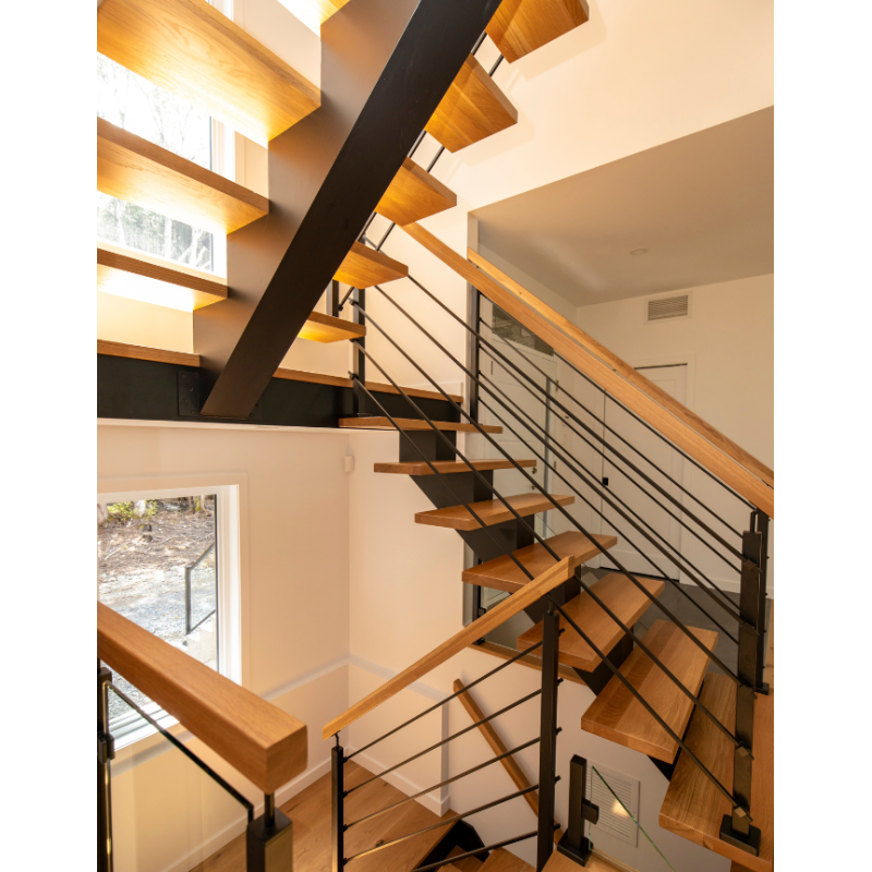 Floating multi-landing wood staircase with rod railings and central ...