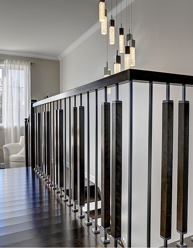 Wood staircase with metal and wood baluster, and steel posts