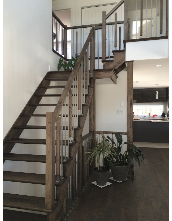 Interior wood staircase with stainless steel, metal and wood balusters
