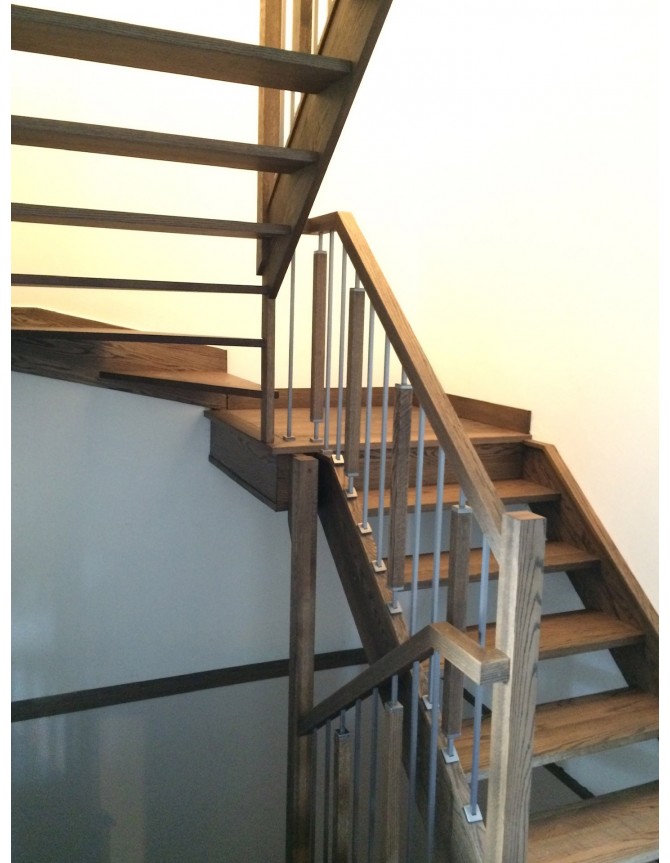 Interior wooden staircase with stainless steel, wood and metal balusters